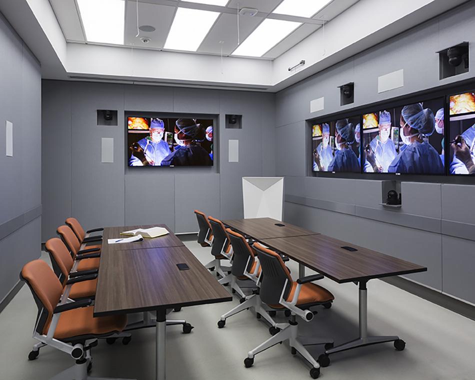 Monitors in the Conference Room show a simulated operation.